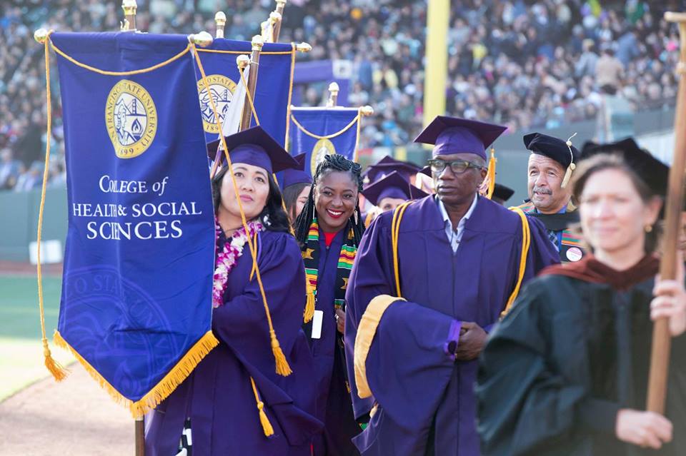 Group with college banner at SF State 2017 commencement