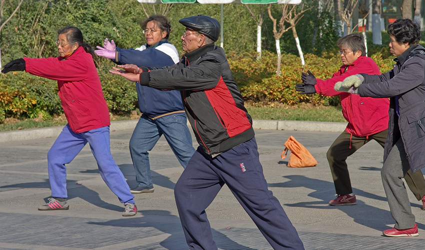 group of older Asian people exercising outdoors