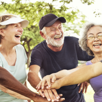 Diverse group of older people with hands together